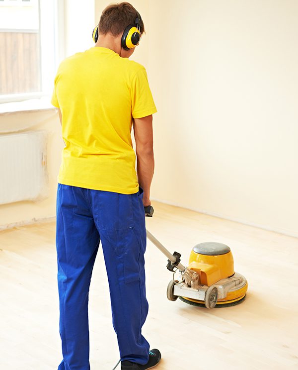 Parquet Floor maintenance by grinding machine carpenter doing parquet Wood Floor polishing maintenance work by grinding machine